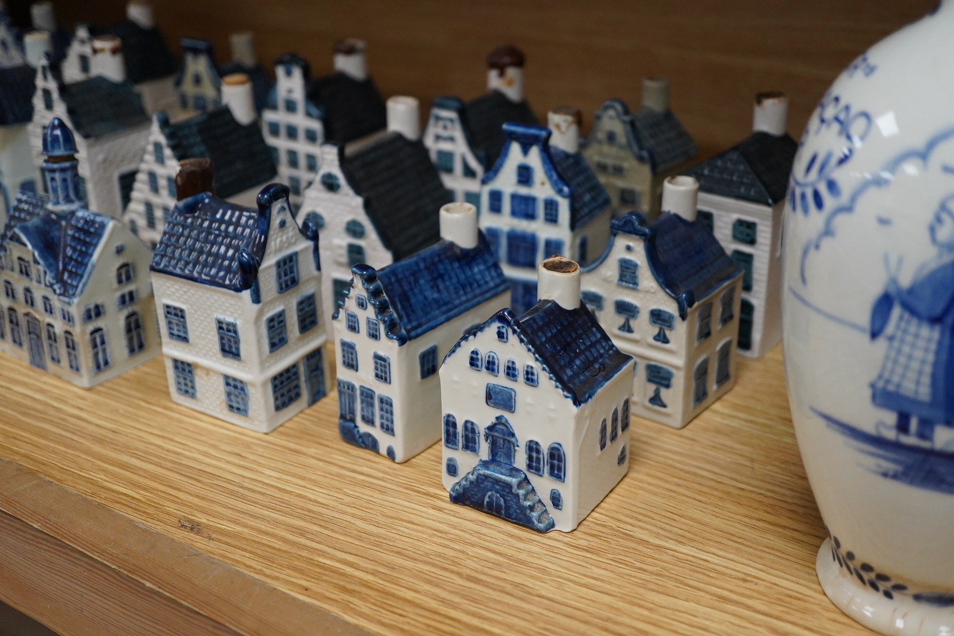 A collection of twenty seven KLM Delft blue miniature houses presented to Business class passengers together with a Delft jug - 20.5cm high